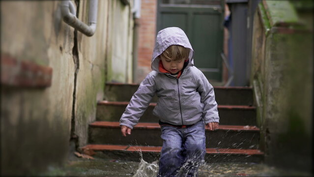 Little Baby Toddler Jumping Into Water Puddle5