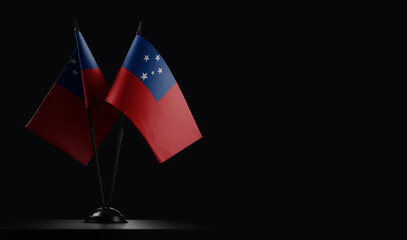 Small national flags of the Samoa on a black background