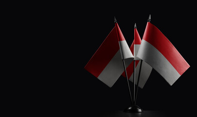 Small national flags of the Indonesia on a black background