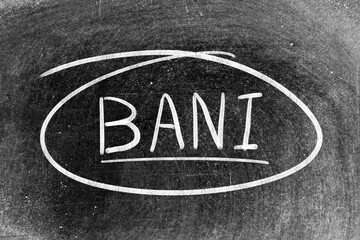 White chalk hand writing in word BANI (Brittle, Anxious, Non-linear and Incomprehensible) and...