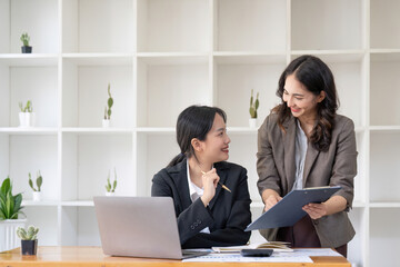 Asian business adviser meeting to analyze and discuss the situation on the financial report in the meeting room.Investment Consultant, Financial advisor and accounting concept