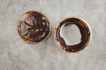 Small plastic bowl with delicious chocolate sauce for dip anything. Top view