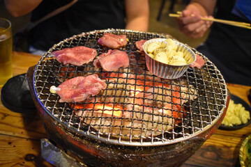 grilling some meat on charcoal stove