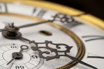 Vintage Clock with Hands.
Close up view on clock face of a historical watches with golden frame