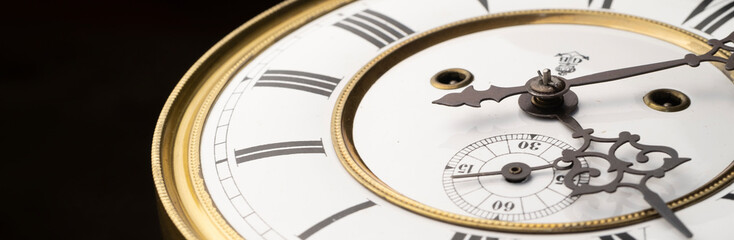 Vintage Clock with Hands.
Close up view on clock face of a historical watches with golden frame