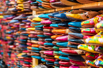 Colorful handmade leather slippers waiting for clients at shop in Fes, next to tanneries, Morocco, Africa