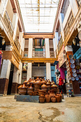 Shop in the courtyard with traditional tajine pot in the middle, Fes, Morocco, Africa