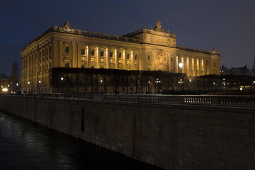 Night view of the Riksdag. It is the Parliament House of Sweden and is located on Helgeandsholmen island, in the Gamla stan district, the old town of Stockholm, in Sweden.