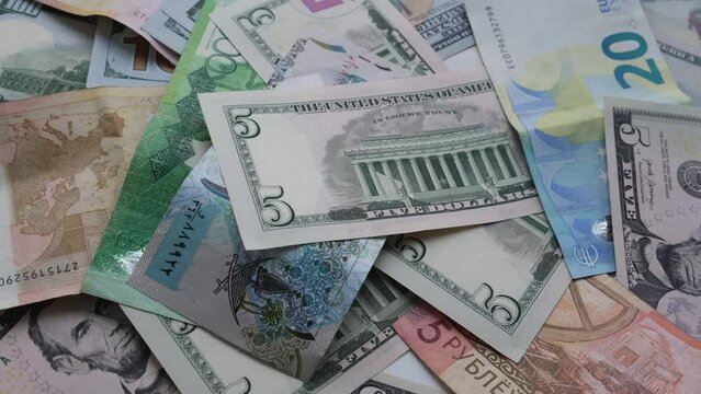 Background from different banknotes of dollars, euros, rubles, Belarusian rubles and other currency. Concept of economic crisis and save money