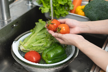 people washing raw vegetables at sink in the kitchen prepare ingredient for cooking
