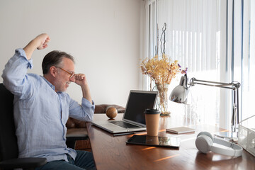 Man making triumph gesture while using netbook