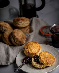 Freshly baked scones with cranberry-cherry preserves