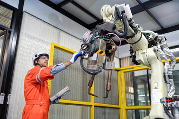 Engineer testing operation robot arm after maintenance and programing ready to send to industry