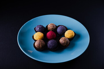 Sweets multi-colored round on a dark concrete background