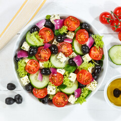 Greek salad with fresh tomatoes olives and feta cheese healthy eating food from above on a wooden board square