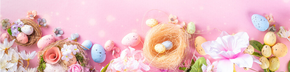 Spring Easter holiday top view flat lay background with eggs in nests and flowers. Happy Easter  greeting card background with copy space, on pastel pink background copy space
