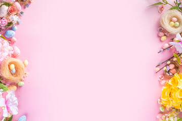 Spring Easter holiday top view flat lay background with eggs in nests and flowers. Happy Easter  greeting card background with copy space, on pastel pink background copy space