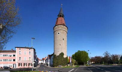 Panoramic view of a street and the medieval Falterturm tower with its leaning spire in the town of Kitzingen, Germany