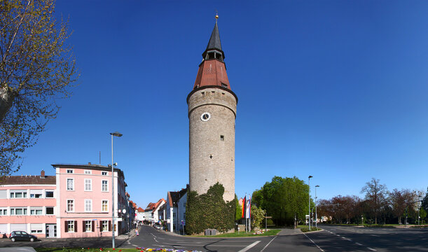 Panoramic view of a street and the medieval Falterturm tower with its leaning spire in the town of Kitzingen, Germany