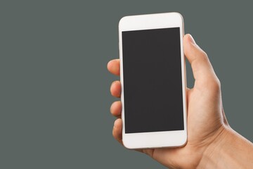 Hands hold a phone with a blank screen