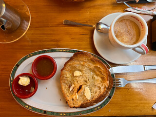Traditional Madrid breakfast with coffee with milk and grilled croissant