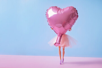 The doll with heart-shaped balloon. Valentine's Day creative concept