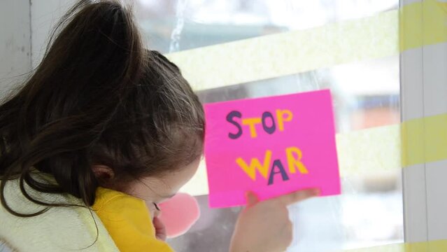 Children against war. Child during the war in Ukraine. War in Ukraine. Rocket strikes on Ukrainian cities. Peace concept. Russian aggression in Ukraine. Winter in Ukraine during the war.