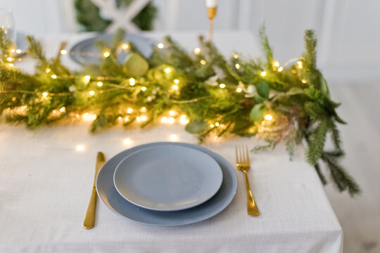 Table with Christmas decor and plate