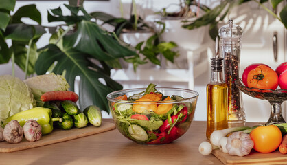 Salad. Vegetable Fresh Salad with Tomatoes, Cucumbers, Scallion and Olive Oil. Healthy Food. Vegetarian Diet. Making vegetable salad in the kitchen at home, Cutting Vegetables close-up