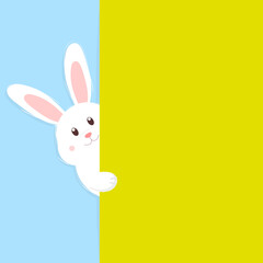 Obraz premium Cute Easter bunny peeking out from behind a green wall