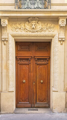 Paris, an ancient wooden door, beautiful facade in the 11e arrondissement
