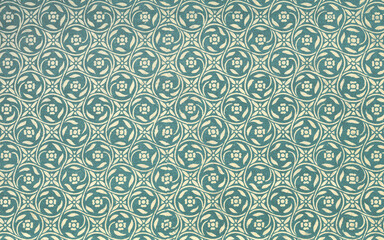 Used antique floral wallpaper or tapestry with flowers and abstract shapes, circa 1912 © Annchronick