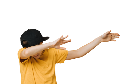 Young boy dressed in yellow t-shirt and black baseball cap over transparent background makes teenagers dab gesture, moves his hands aside, covering his face, that means i did it. Youth culture concept