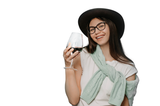 Happy brunette wearing white t-shirt hat and sweater tied up over her shoulders, holds a glass of red wine, celebrates the end of quarantine, over transparent background. Happy people concept
