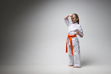 Protective blocking in karate. Strong little girl training.