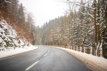 Road to Spindleruv Mlyn in winter with lot of snow and snow barriers. Mountain road near Hradec Kralove, Czech republic