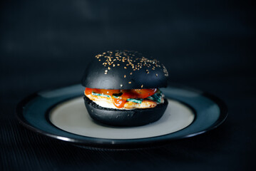 burger with black bun, with meat and cheese