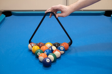 Multicolored billiards, billiard balls on a blue table, colored balls on a billiard table, play snooket