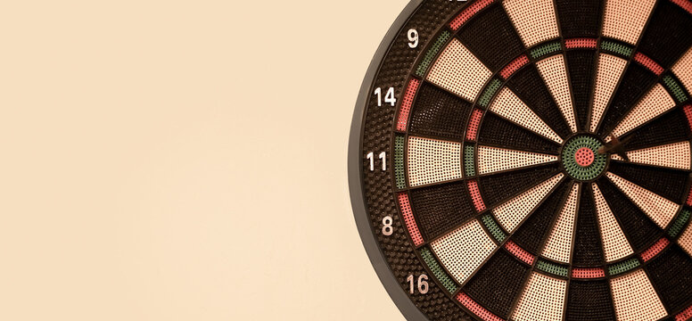 a darts game, an arrow in the center of the target, the target is hit in the center with arrows, isolated on a beige background