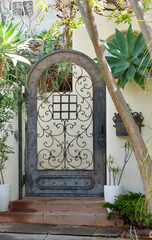 decorative arched metal gate leading to the garden