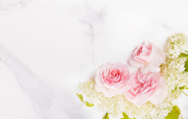 Fototapeta na wymiar Festive flower composition on marble background. Overhead view