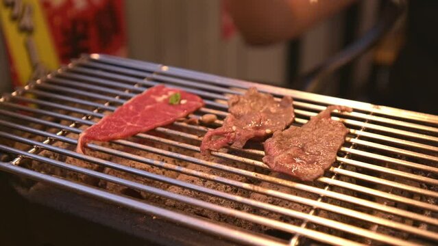 4K, Charcoal grilled Kobe Wagyu beef sliced Yakiniku , gourmet Japanese-style bbq. Cooking grill beef on net grilled in restaurant.
Thinly sliced wagyu beef on grille for barbecue. meat cuisine.