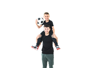 Two brothers with a soccer ball isolated on white background