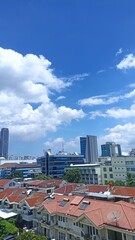 Bright blue sky with white clouds above residential houses