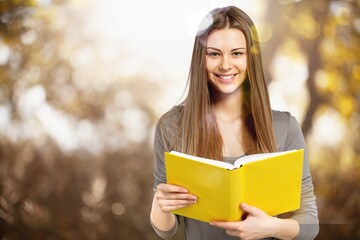 Happy young beautiful woman reading book