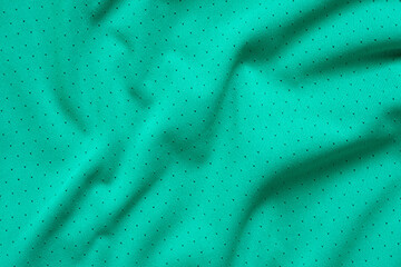 Fototapeta na wymiar Green sports clothing fabric football shirt jersey texture background