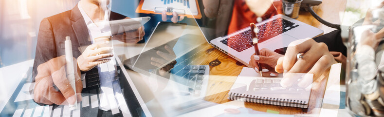 Businessman and team analyzing financial statement Finance task. with smart phone and laptop and...