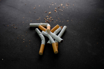 Group of broken cigars on black background.
Concept for quitting smoking and leading a healthy...