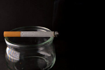 Lit cigarette consuming. Quit smoking campaign
