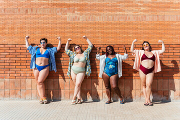 Group of beautiful plus size women with swimwear bonding and having fun at the beach - Group of...